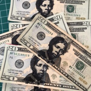 Many U.S. $20 bills that have had Harriet Tubman's face stamped over Andrew Jackson's in black ink.