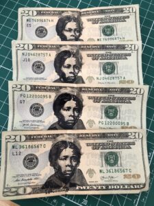 Four United States $20 bills with an image of Harriet Tubman stamped in black ink over Andrew Jackson's face